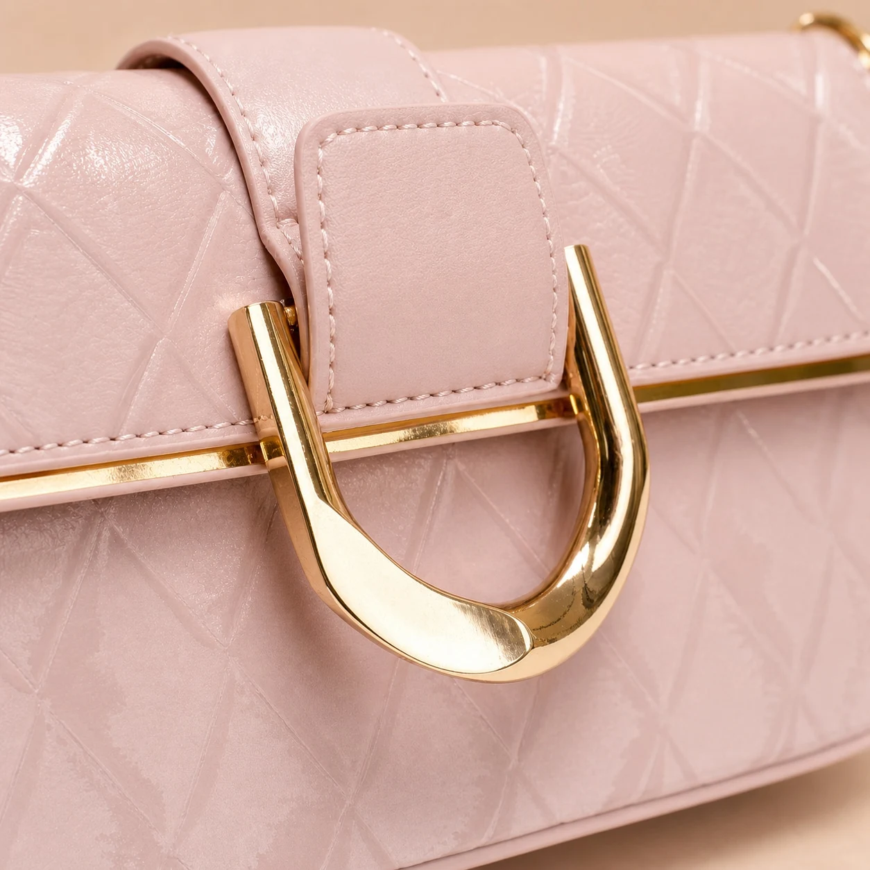 Quilted texture and gold-tone clasp detail