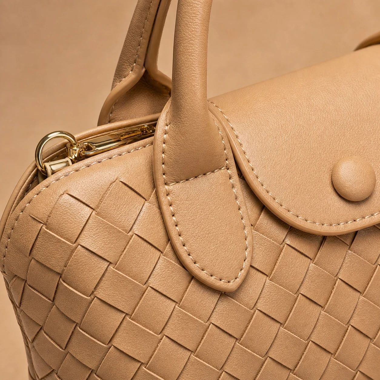 Woven texture handle stitching and gold-tone zipper detail